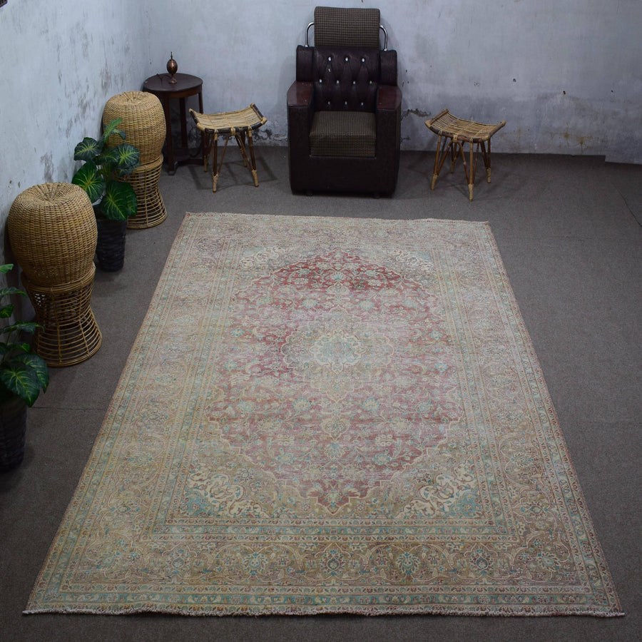 Vintage Persian rug 251x348 cm styled in interior showing soft ivory tones and worn floral design