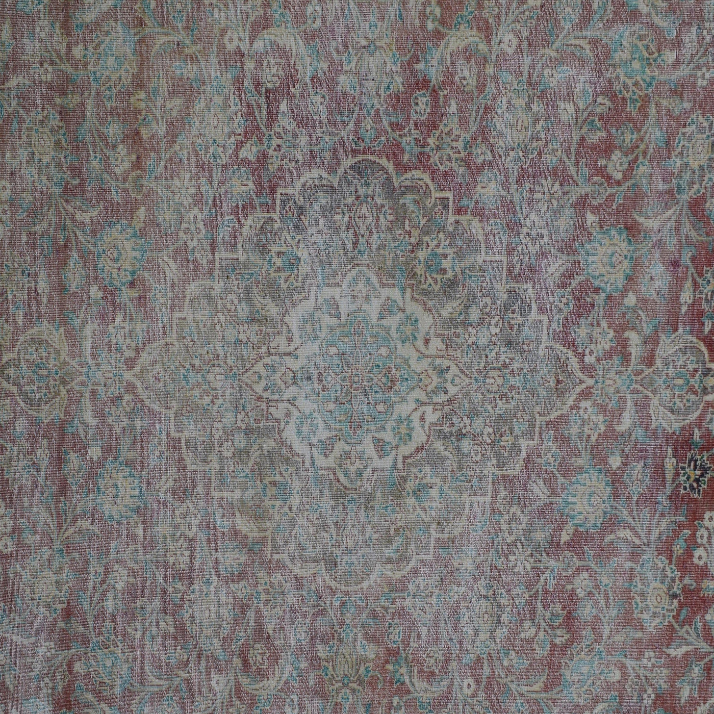 Detailed view of vintage Persian rug medallion featuring traditional Persian floral patterns