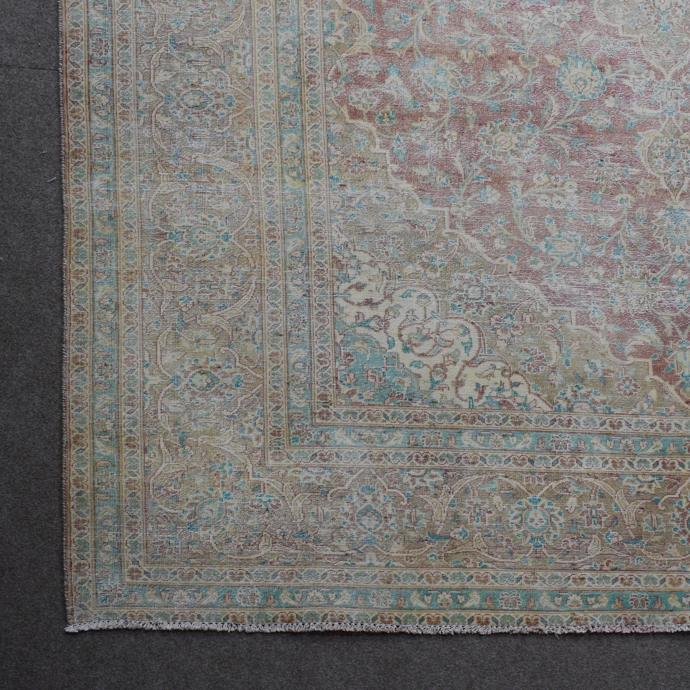 Corner detail of Persian rug with decorative border and classic Persian motifs