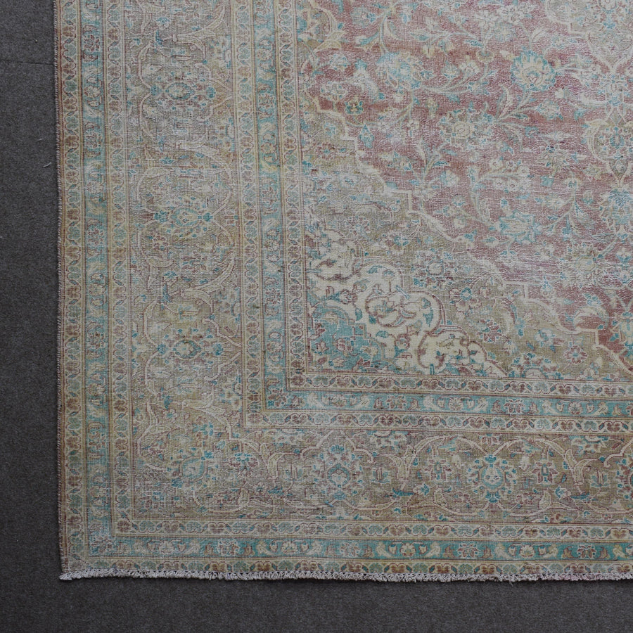 Corner detail of Persian rug with decorative border and classic Persian motifs