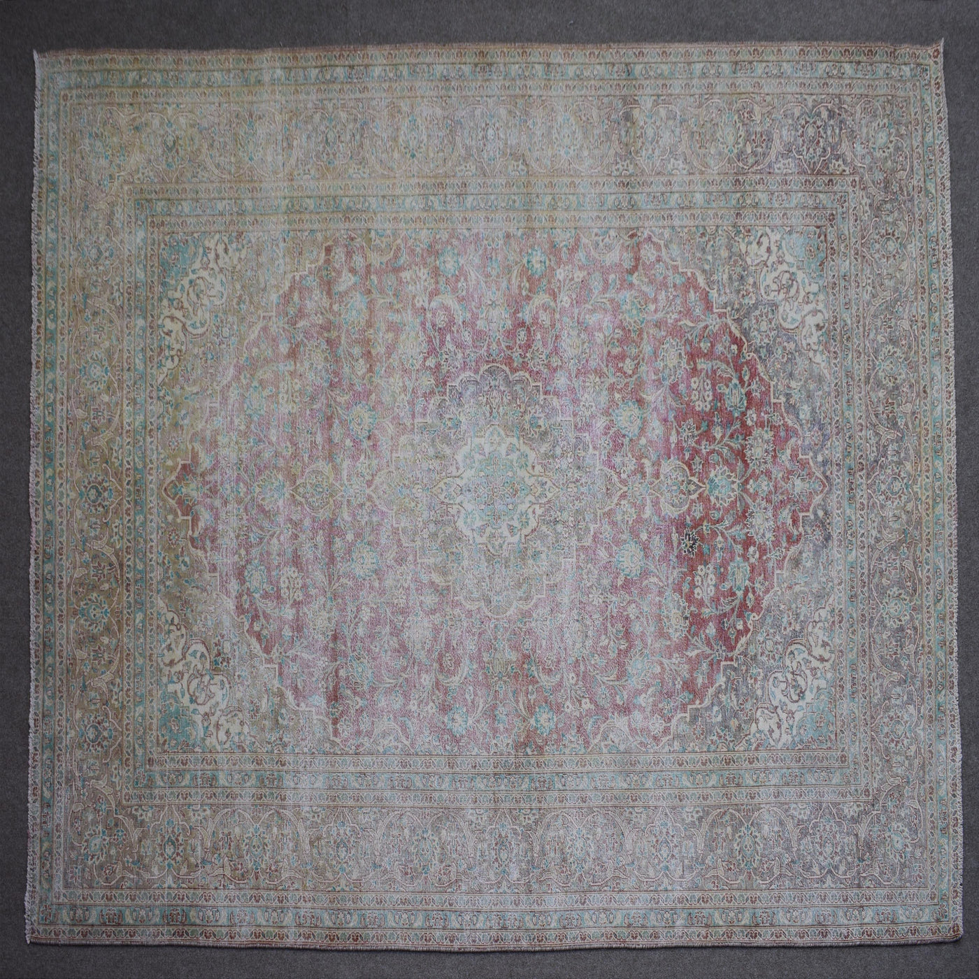 Close up of Persian rug border with colorful floral motifs and intricate guard stripes