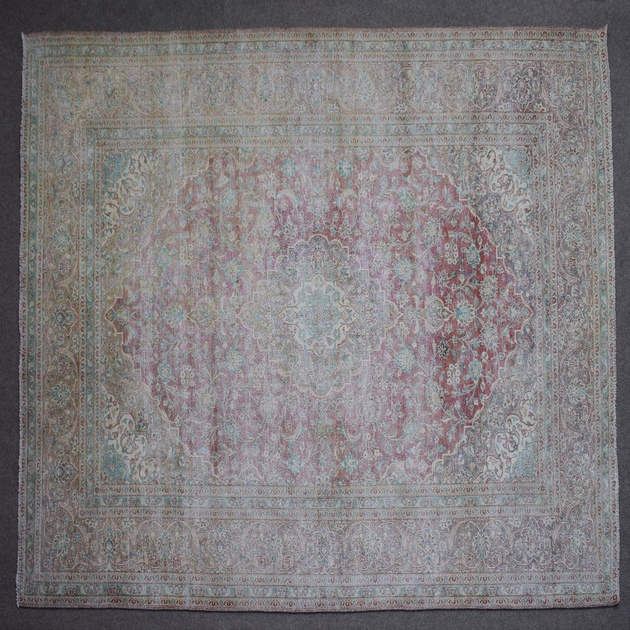 Close up of Persian rug border with colorful floral motifs and intricate guard stripes