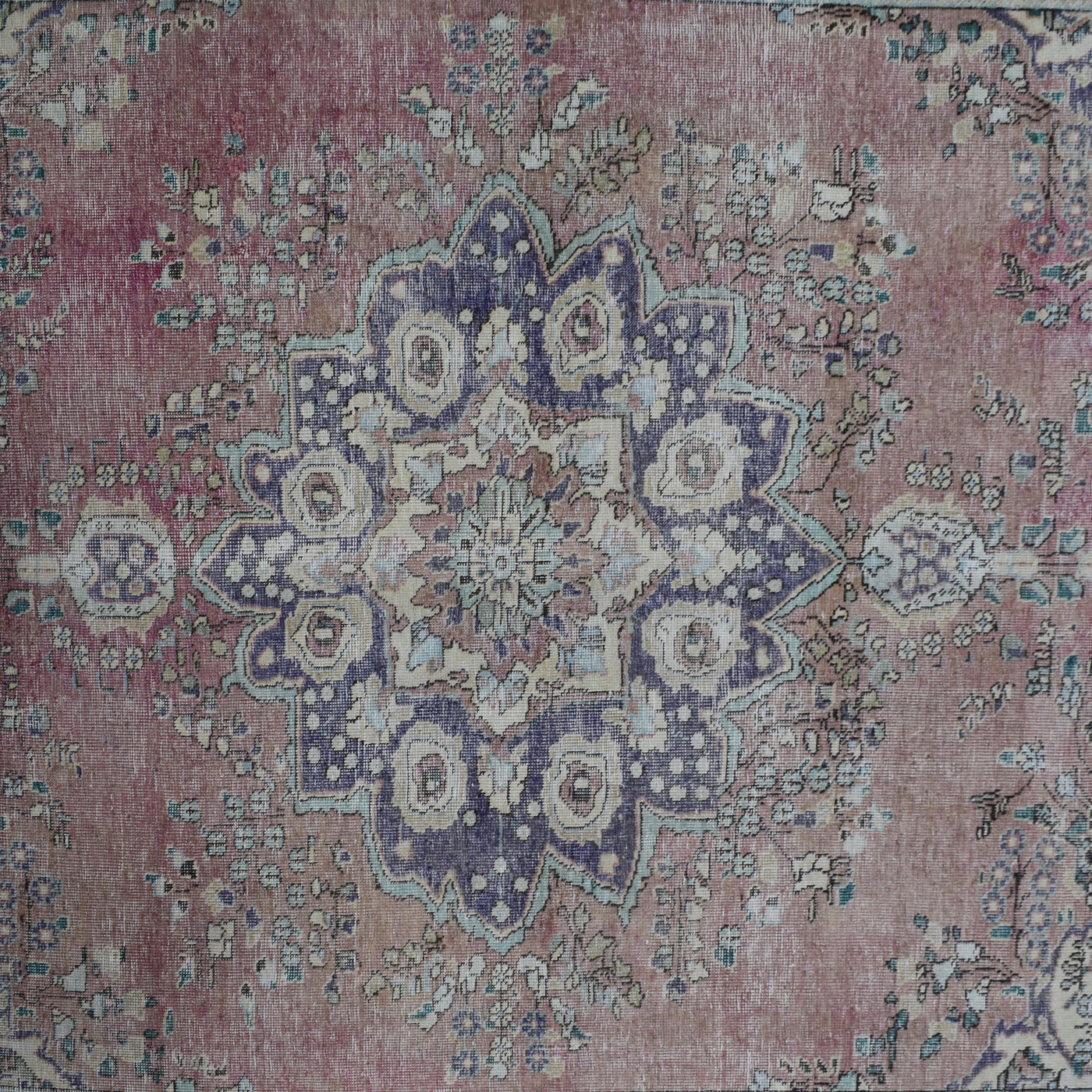 Detailed view of vintage Persian rug medallion featuring traditional Persian floral patterns