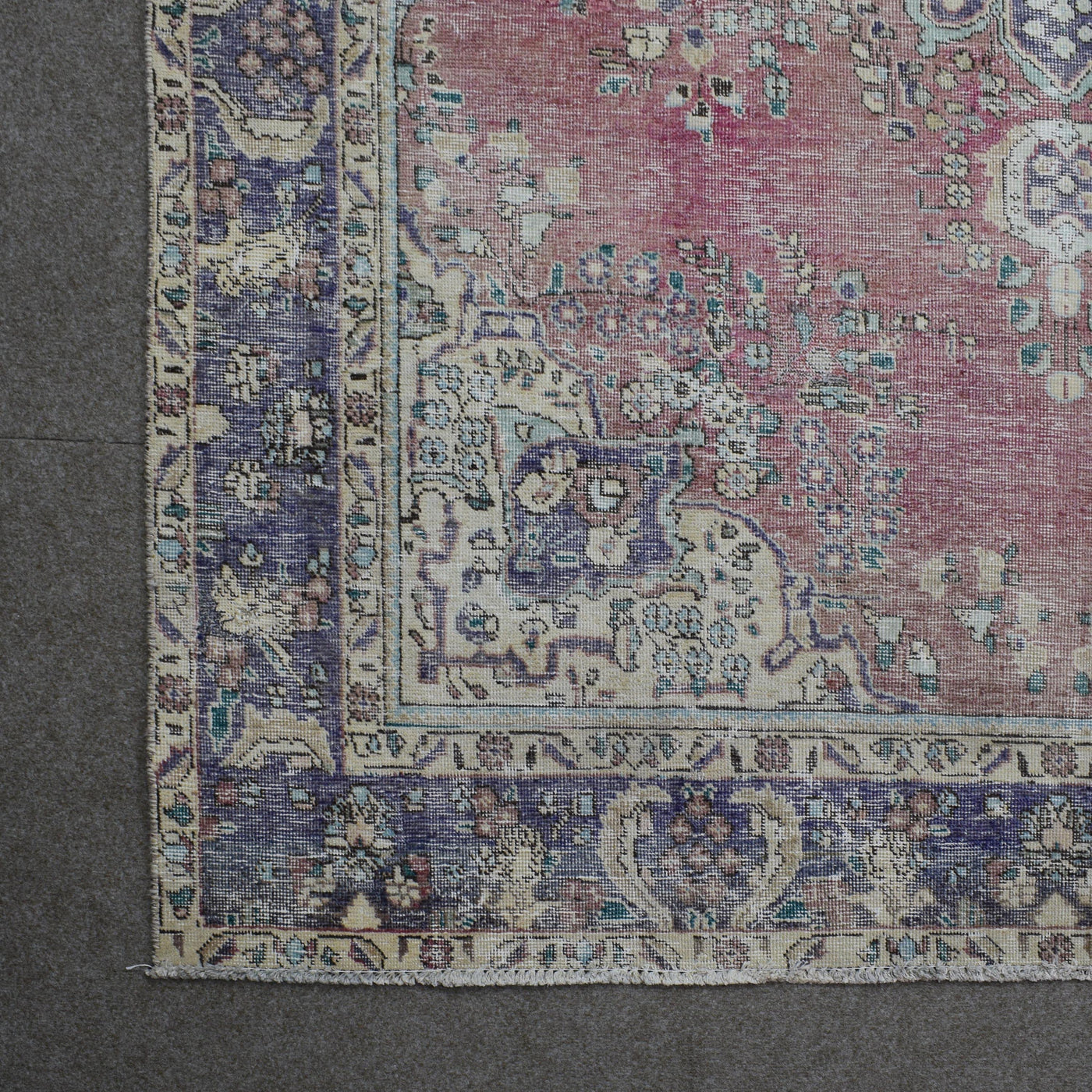 Corner detail of Persian rug with decorative border and classic Persian motifs