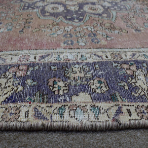 Close up of Persian rug border with deep blue floral motifs and intricate guard stripes