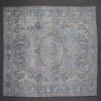 Close up of Persian rug border with blue floral motifs and intricate guard stripes