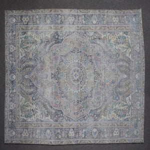 Close up of Persian rug border with blue floral motifs and intricate guard stripes