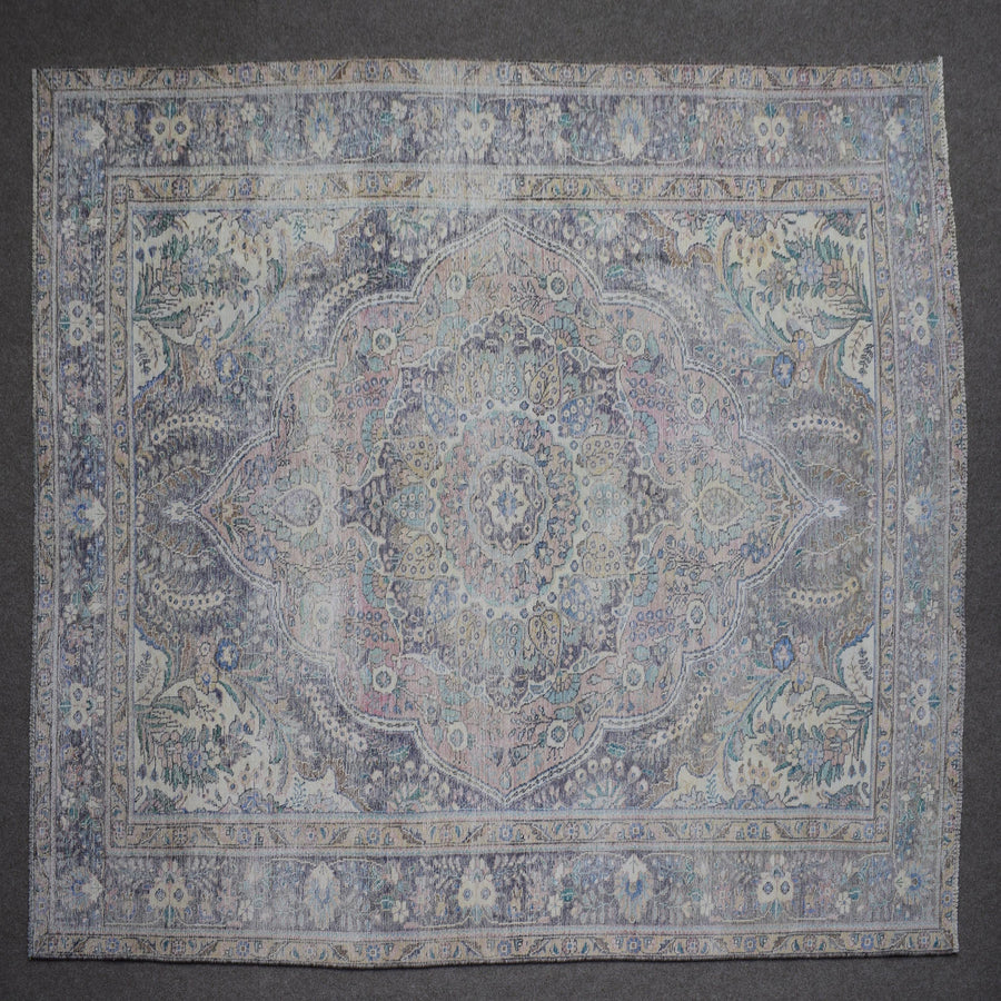 Close up of Persian rug border with blue floral motifs and intricate guard stripes