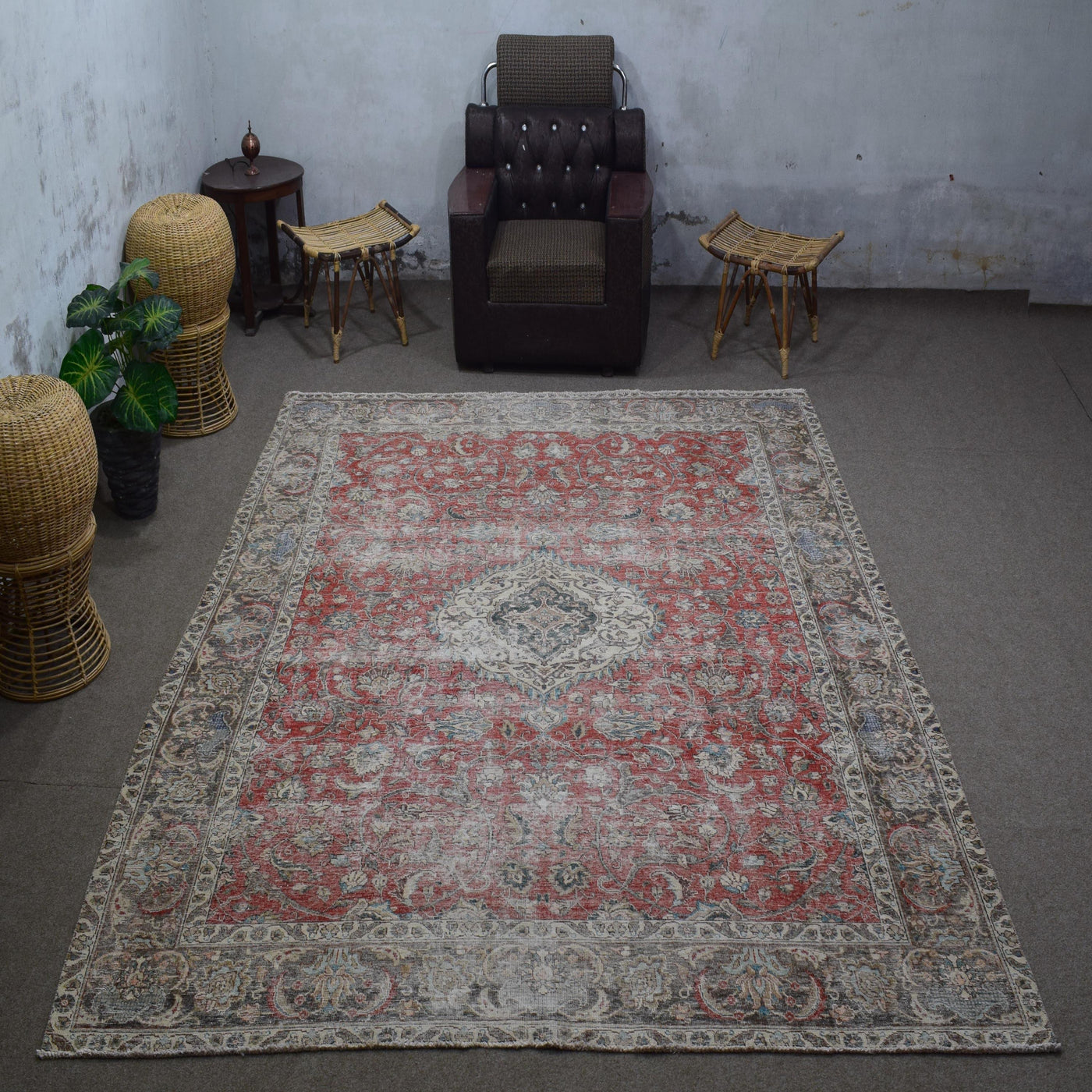 Vintage Persian rug 253x327 cm styled in interior showing distressed red tones and classic medallion design