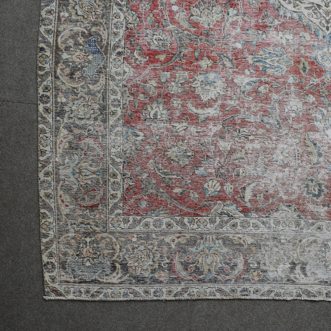 Corner detail of Persian rug with decorative border and classic Persian motifs