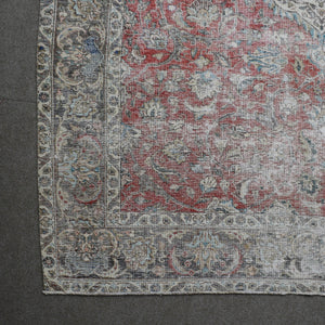 Corner detail of Persian rug with decorative border and classic Persian motifs