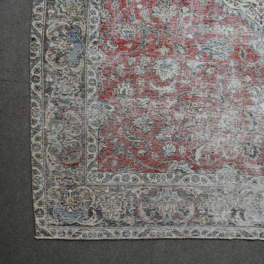 Corner detail of Persian rug with decorative border and classic Persian motifs