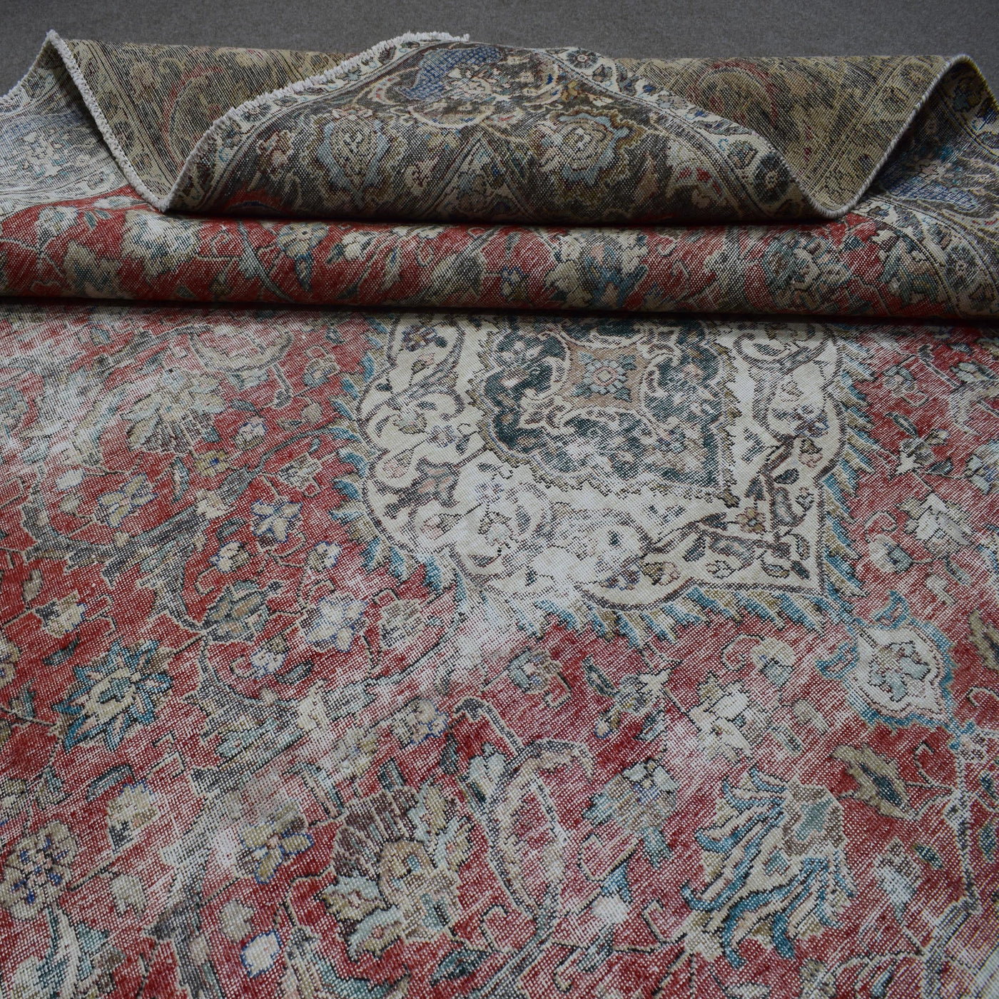 Close up of Persian rug border with colorful floral motifs and intricate guard stripes