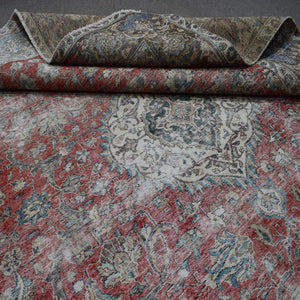 Close up of Persian rug border with colorful floral motifs and intricate guard stripes