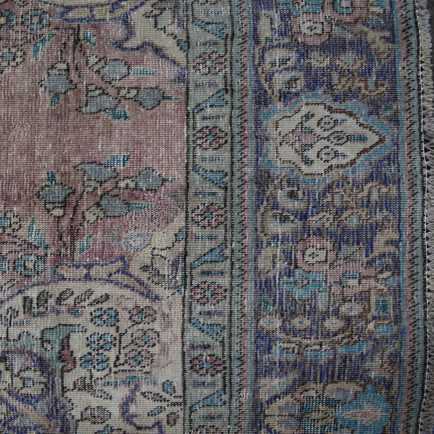 Detailed section of Persian rug border and field showing traditional Persian floral design