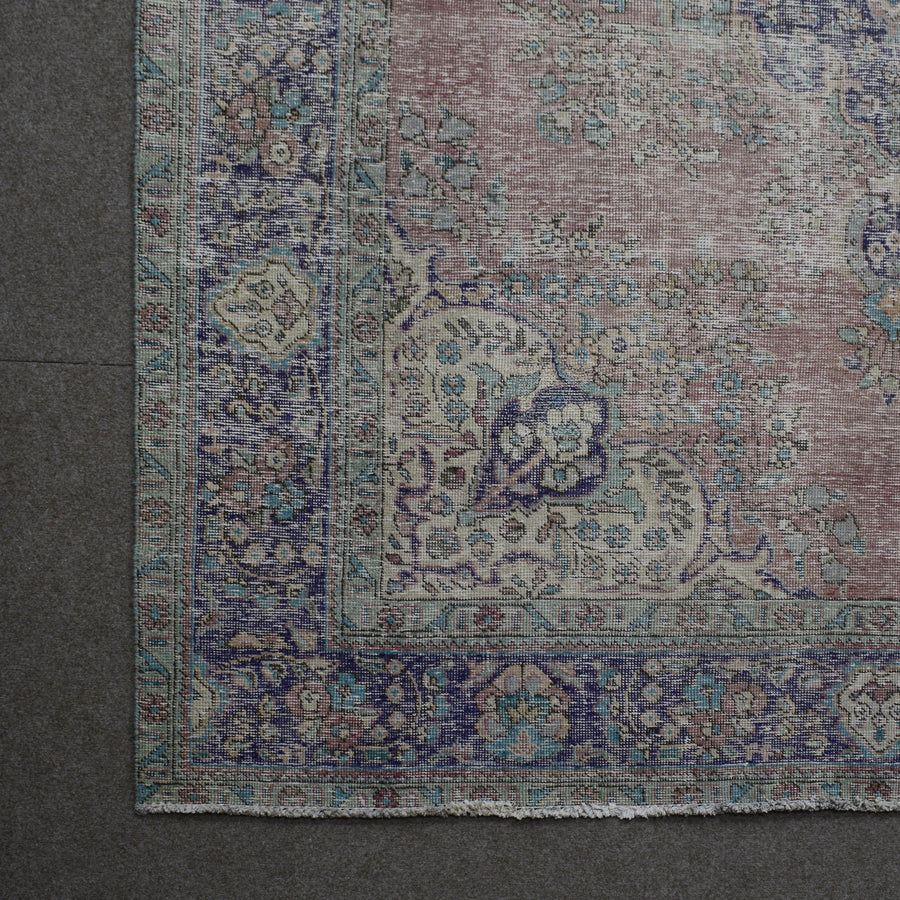 Corner detail of vintage Persian rug showing decorative border and classic Persian motifs