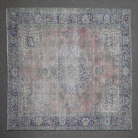 Close up of Persian rug border featuring blue floral pattern and intricate guard stripes