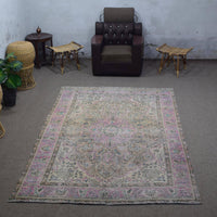 Vintage Persian rug 194x292 cm photographed in interior showing soft distressed tones and central medallion