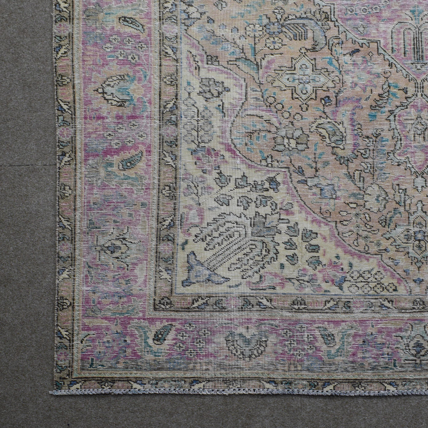 Corner detail of Persian rug showing decorative border and intricate floral elements