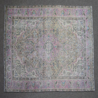 Close up of Persian rug border with pink and blue floral motifs and classic Persian pattern