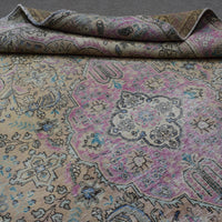 Close up of Persian rug medallion motif with antique pastel palette and intricate details