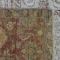 Detailed section of Persian rug patchwork panels with traditional floral ornamentation