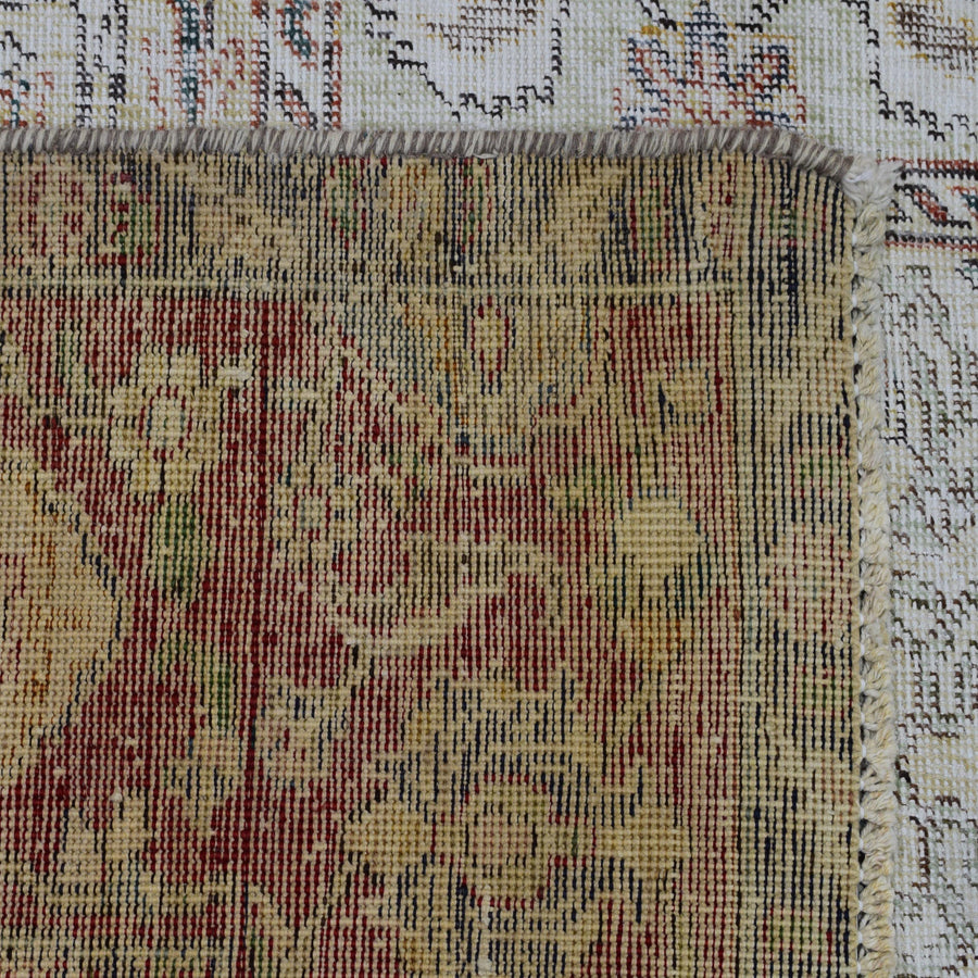 Detailed section of Persian rug patchwork panels with traditional floral ornamentation