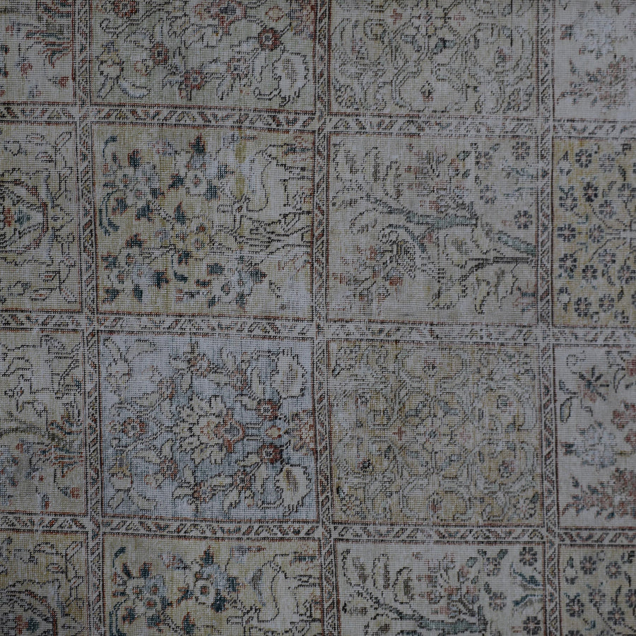 Detailed view of vintage Persian rug patchwork design with multiple decorative squares