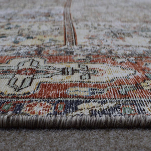 Close up of Persian rug border with red and blue floral pattern and guard stripes