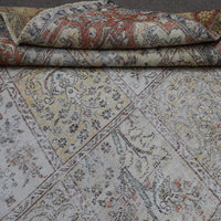 Macro detail of distressed Persian rug weave showing worn wool texture and faded colors