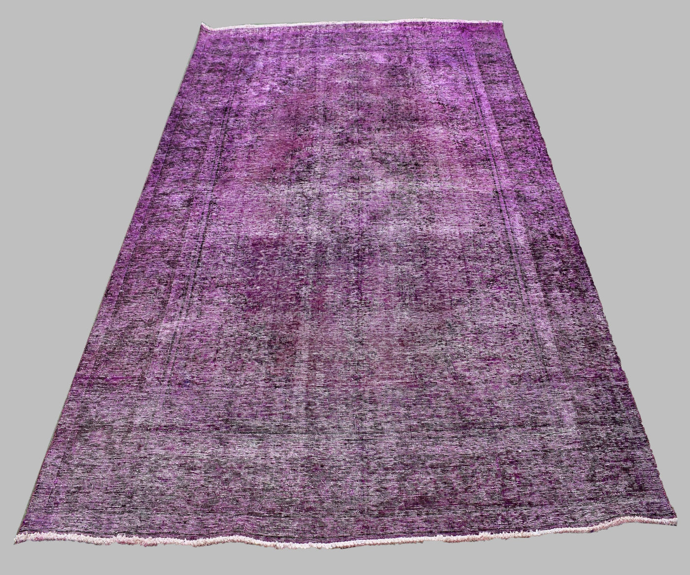 Large overdyed vintage Persian rug 227x330 cm full view showing faded traditional pattern beneath purple wash
