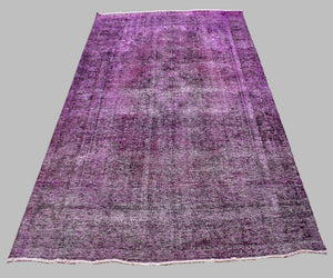 Large overdyed vintage Persian rug 227x330 cm full view showing faded traditional pattern beneath purple wash
