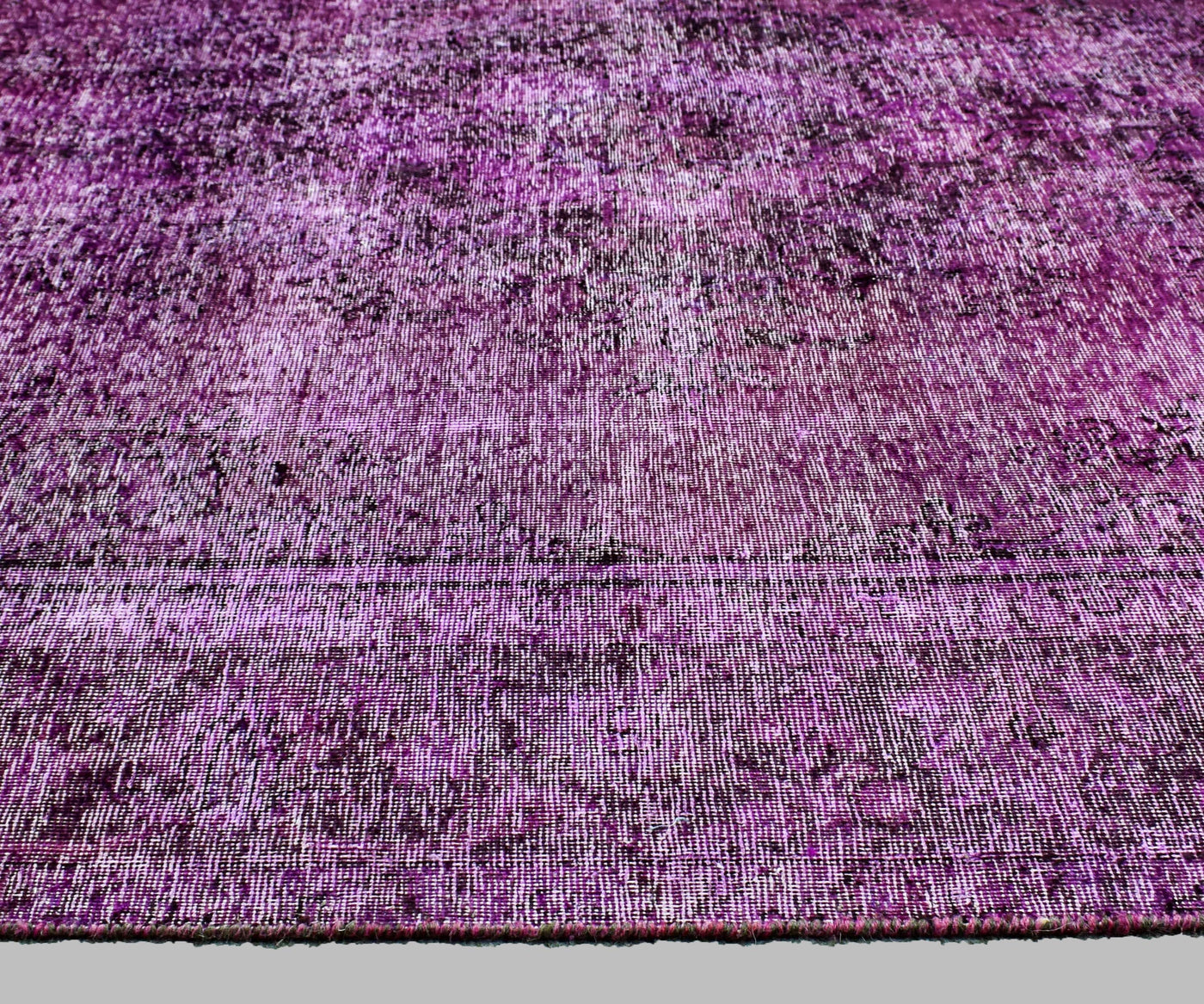 Detailed surface view of overdyed Persian rug with subtle erased floral pattern and worn effect
