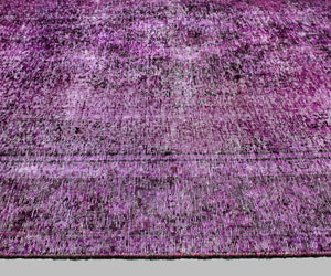 Detailed surface view of overdyed Persian rug with subtle erased floral pattern and worn effect
