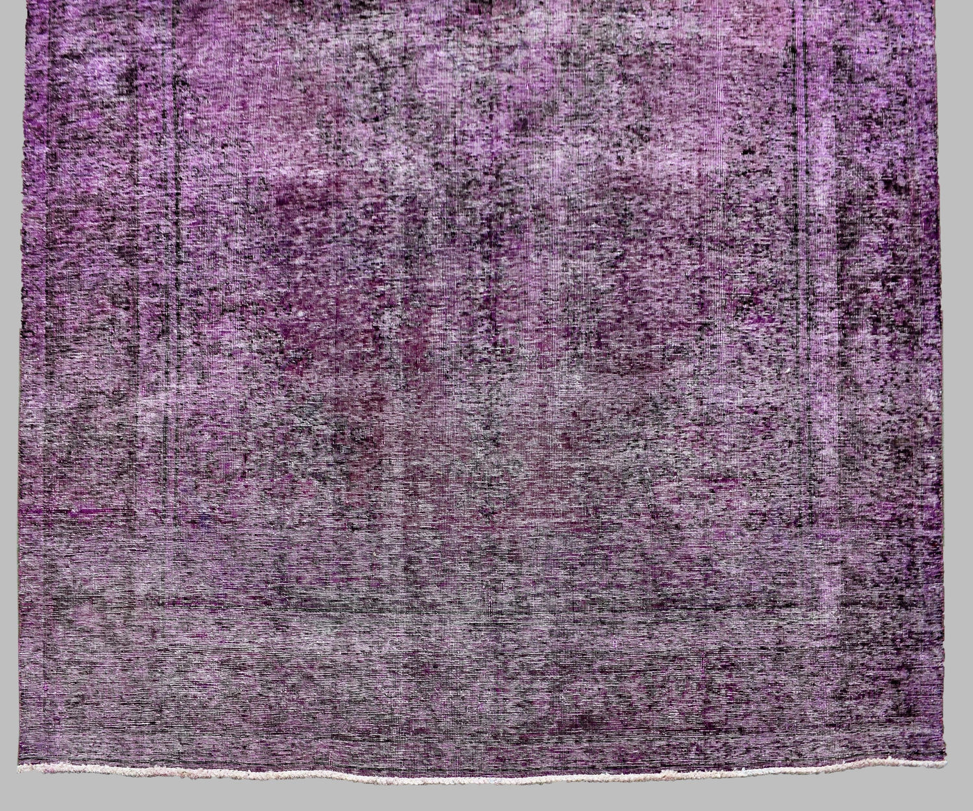 Side section detail of large overdyed rug highlighting tonal shading and vintage patina
