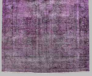 Side section detail of large overdyed rug highlighting tonal shading and vintage patina
