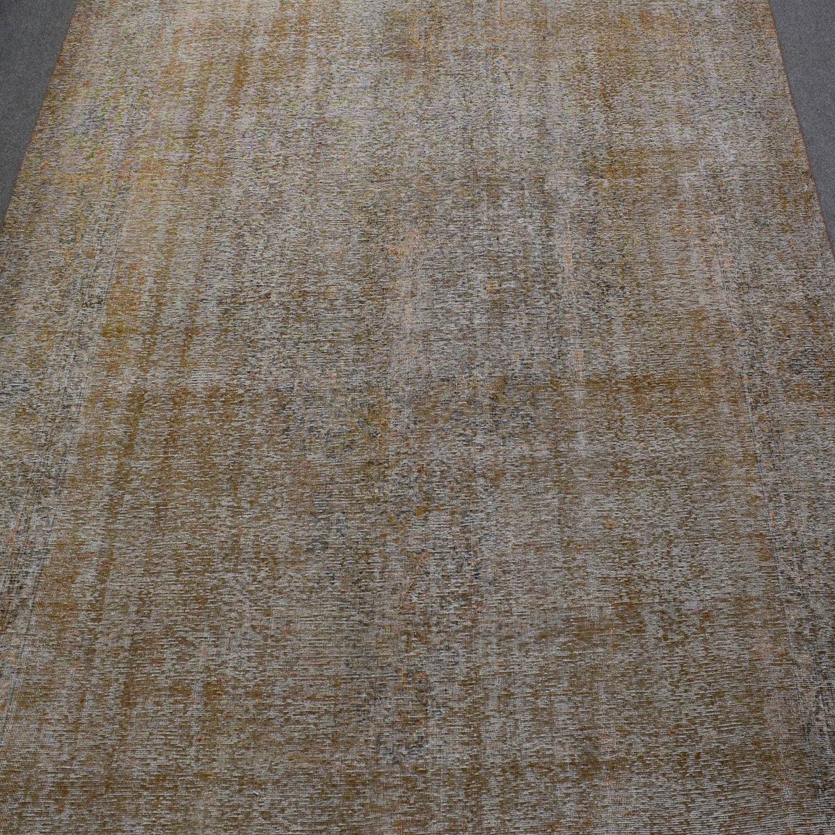 Overdyed Persian rug with distressed antique look and soft beige tonal variations
