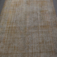 Overdyed Persian rug with distressed antique look and soft beige tonal variations
