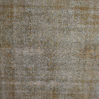 Close-up of overdyed vintage Persian rug showing textured wool pile and muted neutral tones

