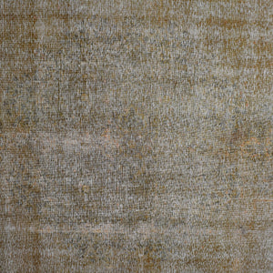 Close-up of overdyed vintage Persian rug showing textured wool pile and muted neutral tones
