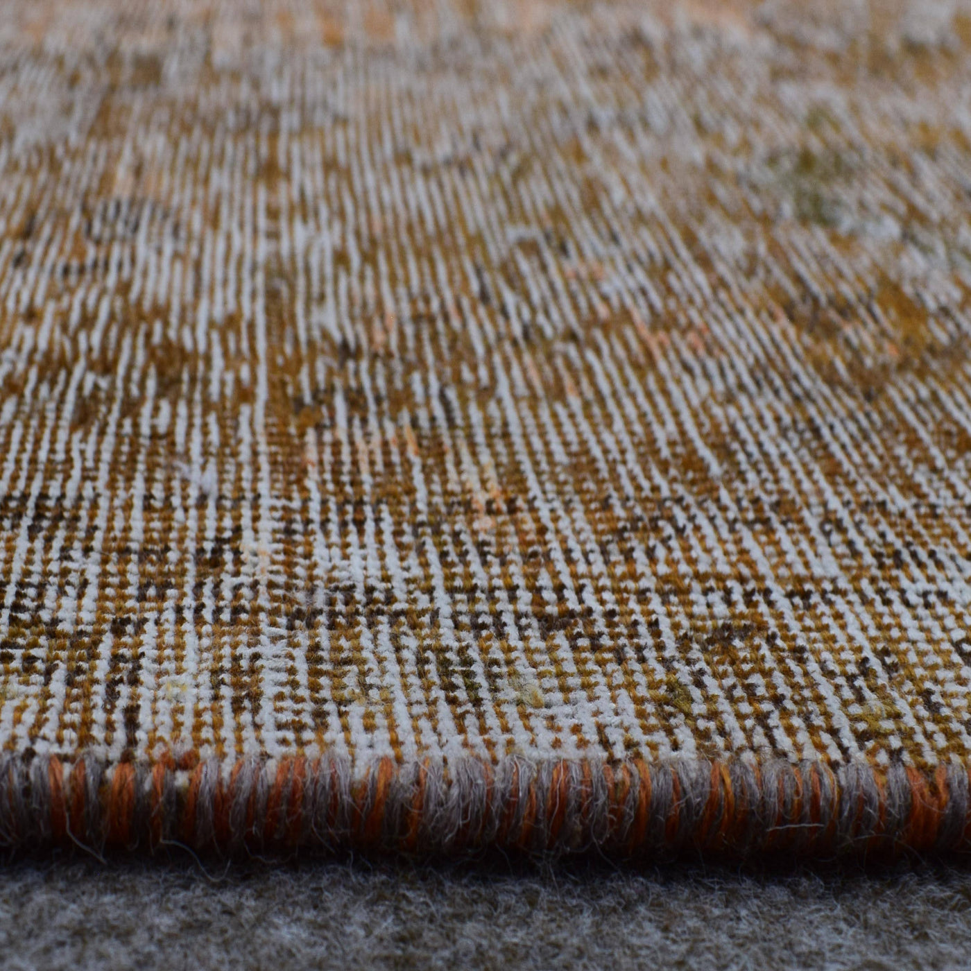 Angled view of large overdyed rug emphasizing subtle shading and minimalist character
