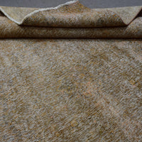 Macro detail of overdyed Persian rug showing dense hand knotted weave structure

