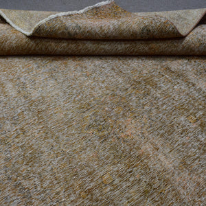 Macro detail of overdyed Persian rug showing dense hand knotted weave structure
