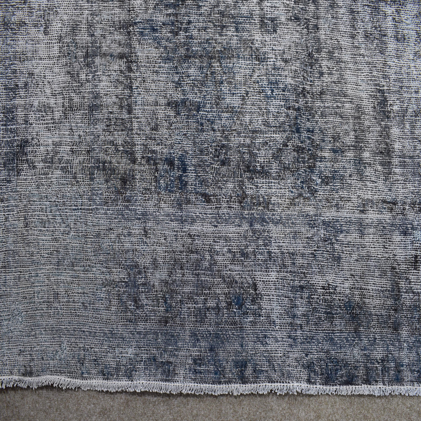 Detailed pile texture of grey blue overdyed Persian rug showing authentic wool foundation
