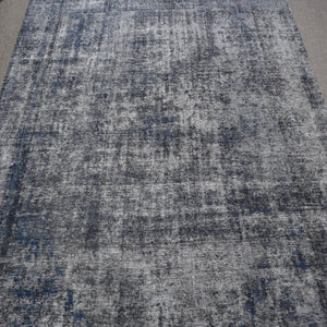 Overdyed Persian rug with antique distressed look and cool grey tonal variations
