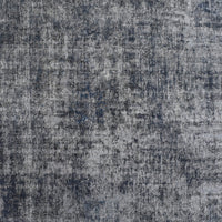 Close-up of overdyed vintage Persian rug showing textured wool pile and mottled grey blue tones
