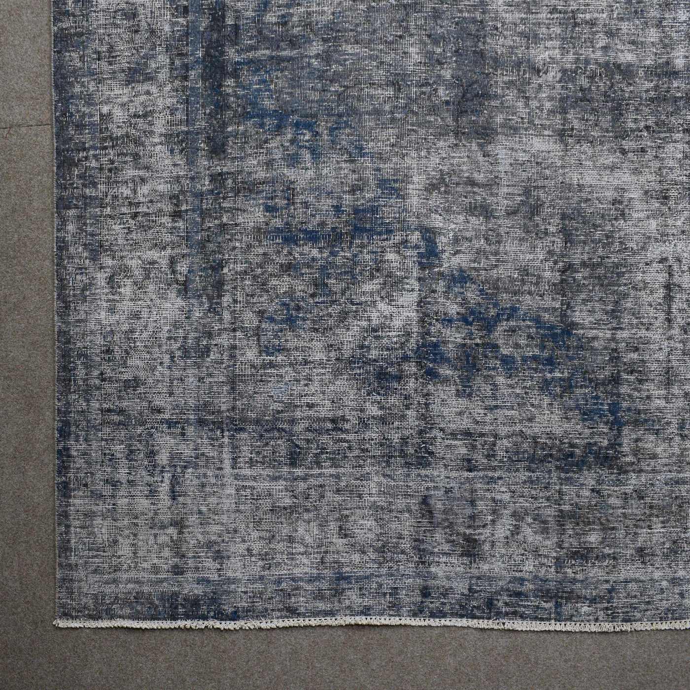 Detailed surface view of grey overdyed Persian rug highlighting worn vintage patina
