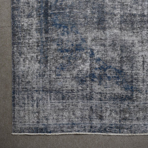 Detailed surface view of grey overdyed Persian rug highlighting worn vintage patina
