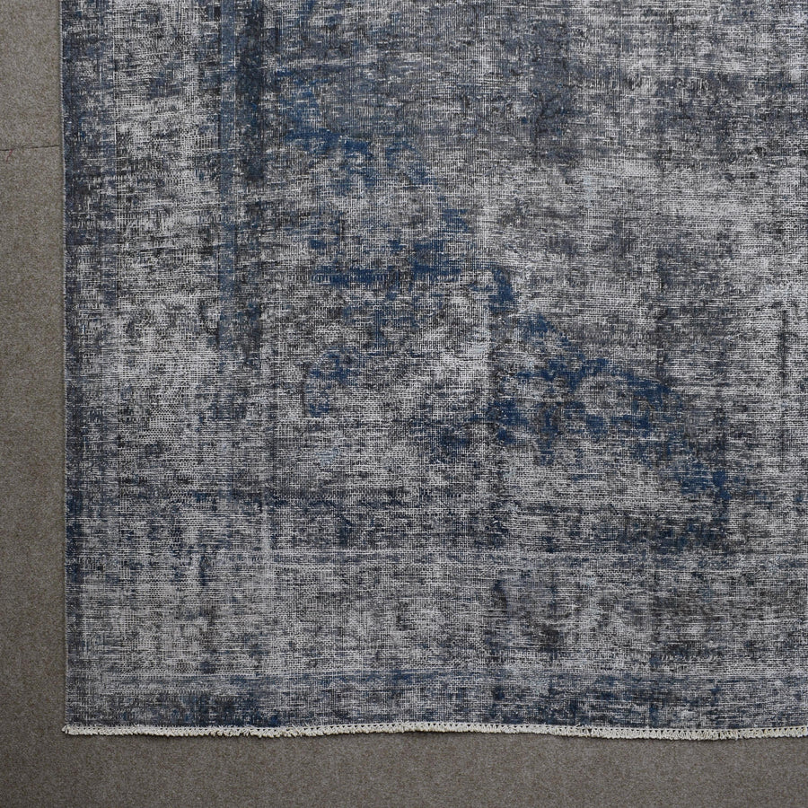 Detailed surface view of grey overdyed Persian rug highlighting worn vintage patina
