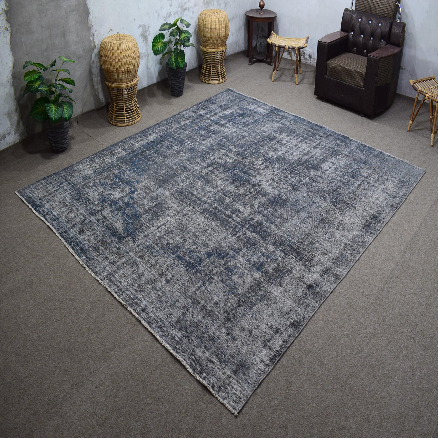 Angled view of large overdyed rug emphasizing subtle shading and modern minimalist character
